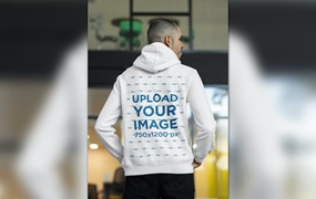 办公室男性背影连帽衫设计样机图 Back View of a Man Wearing a Hoodie at The Office
